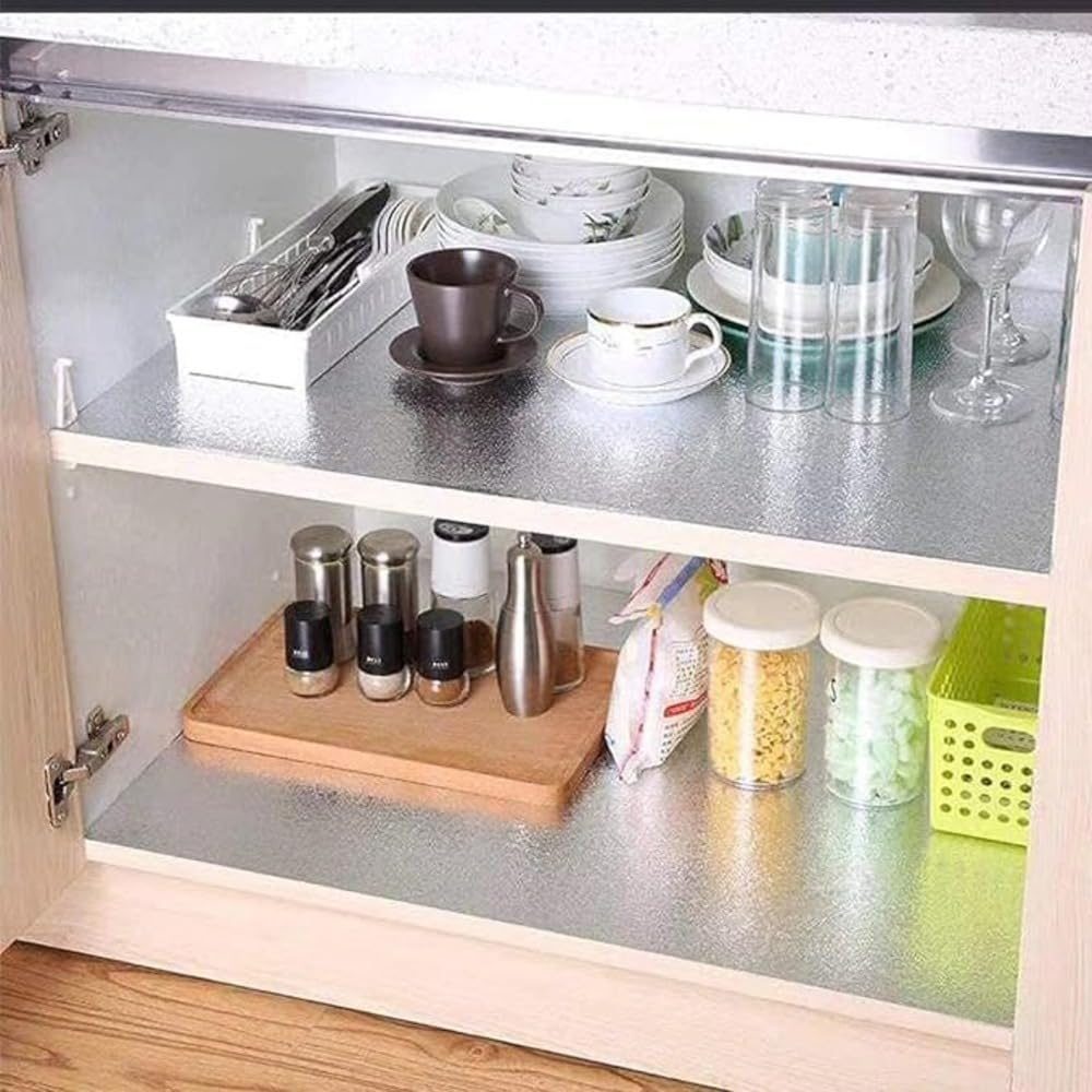 Foil lining the shelves inside a kitchen cabinet