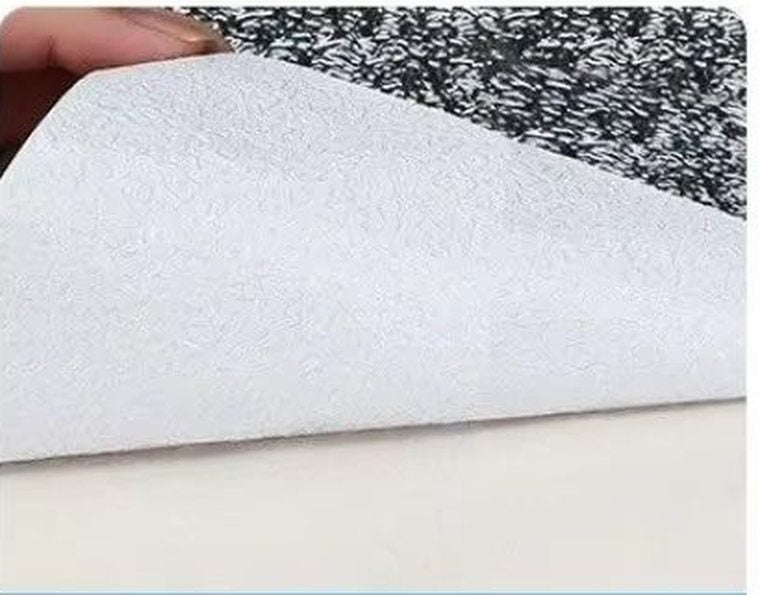 The white backing paper being peeled from the foil