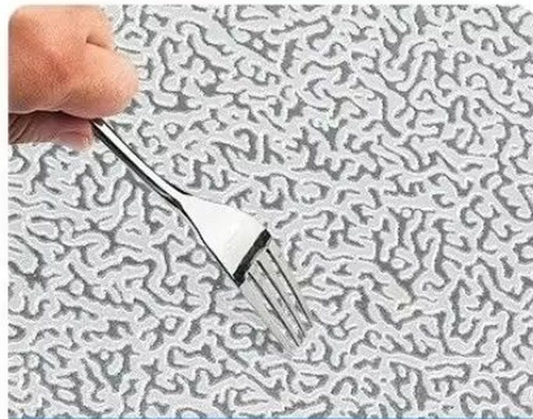 A fork being dragged across the foil surface