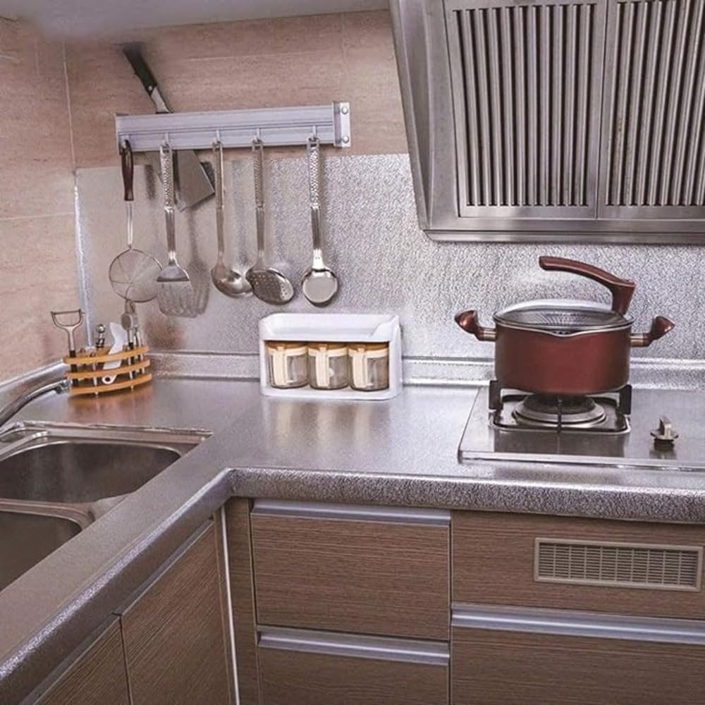 A full kitchen with foil on the counters and walls