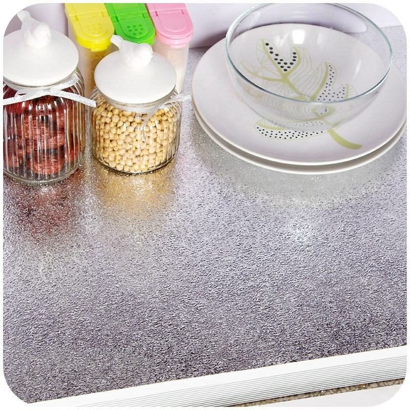 Foil lining a shelf with jars and crockery on it